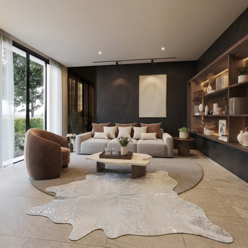 Silver on off-white metallic cowhide rug styled on the stone-tiled floor of a contemporary monochrome living room