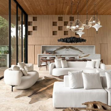 Caramel and ivory exotic printed cowhide rug styled on the floor of an editorial interior