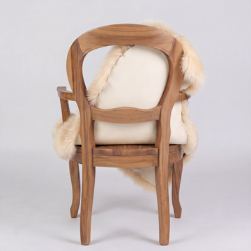 Champagne sheepskin over an armchair back, suede leather underside facing the camera