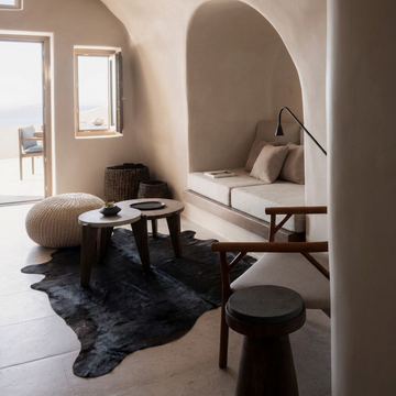 Caramel and ivory exotic printed cowhide rug styled on the floor of an editorial interior
