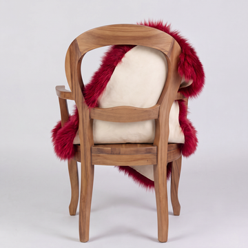 Wildfire red sheepskin over an armchair back, suede leather underside facing the camera