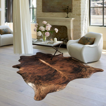 Dark brindle cowhide rug styled on the floor of an editorial interior