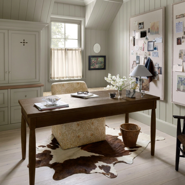 Caramel and ivory exotic printed cowhide rug styled on the floor of an editorial interior