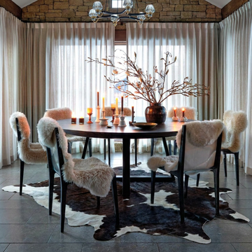 Caramel and ivory exotic printed cowhide rug styled on the floor of an editorial interior