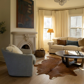 Caramel and ivory exotic printed cowhide rug styled on the floor of an editorial interior