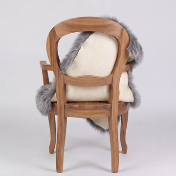 Grey sheepskin over an armchair back, suede leather underside facing the camera