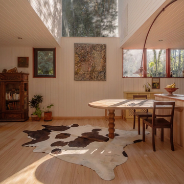 Caramel and ivory exotic printed cowhide rug styled on the floor of an editorial interior