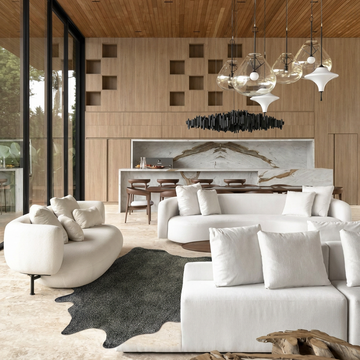 Gold speckled metallic cowhide rug styled on the stone floor of a warm luxurious living room