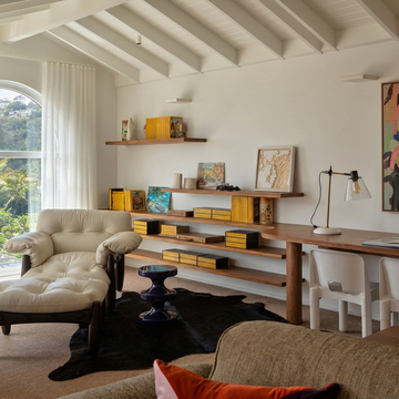 Caramel and ivory exotic printed cowhide rug styled on the floor of an editorial interior