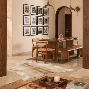 Caramel and ivory exotic printed cowhide rug styled on the floor of an editorial interior