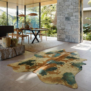 Acid-wash green and tan cowhide rug styled on the stone floor of a warm japandi dining room
