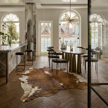 Caramel and ivory exotic printed cowhide rug styled on the floor of an editorial interior