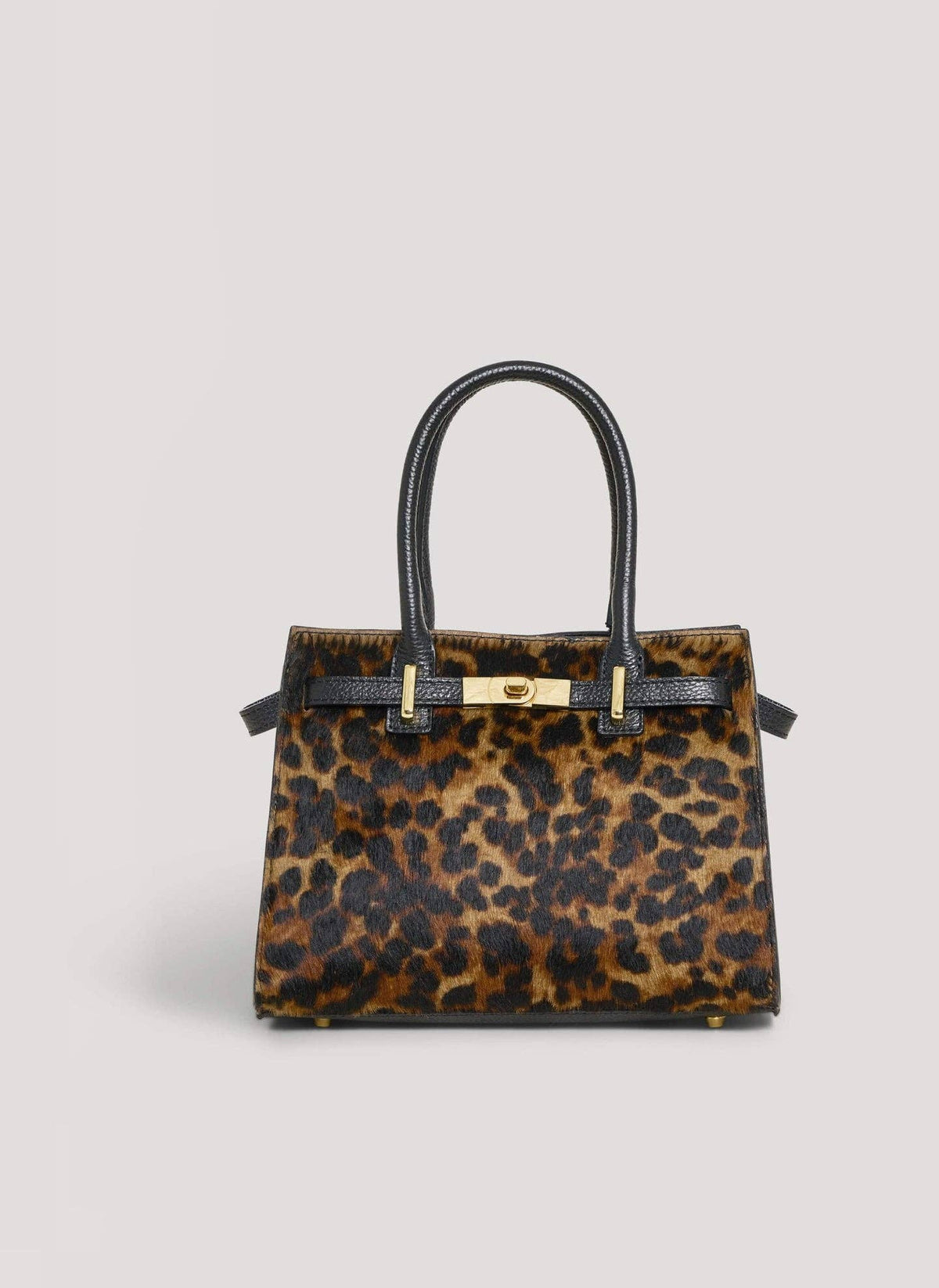 Leonora leopard calf hair top-handle bag by Clemés, front view with gold-tone turn-lock clasp, on a light grey background