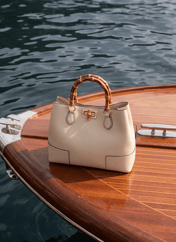 Ginevra Bamboo-Handle Leather Bag by Clemés in White, styled on a boat