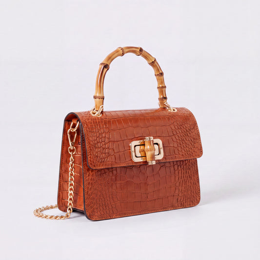 Burnt Orange Clotilde Bamboo Croc Handbag by Clemés, studio shot