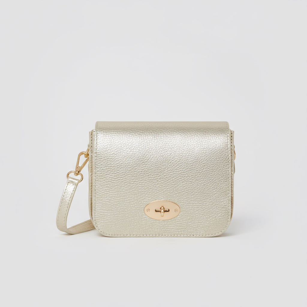 Chiara Leather Crossbody by Clemés in Gold, three-quarter studio shot on grey background