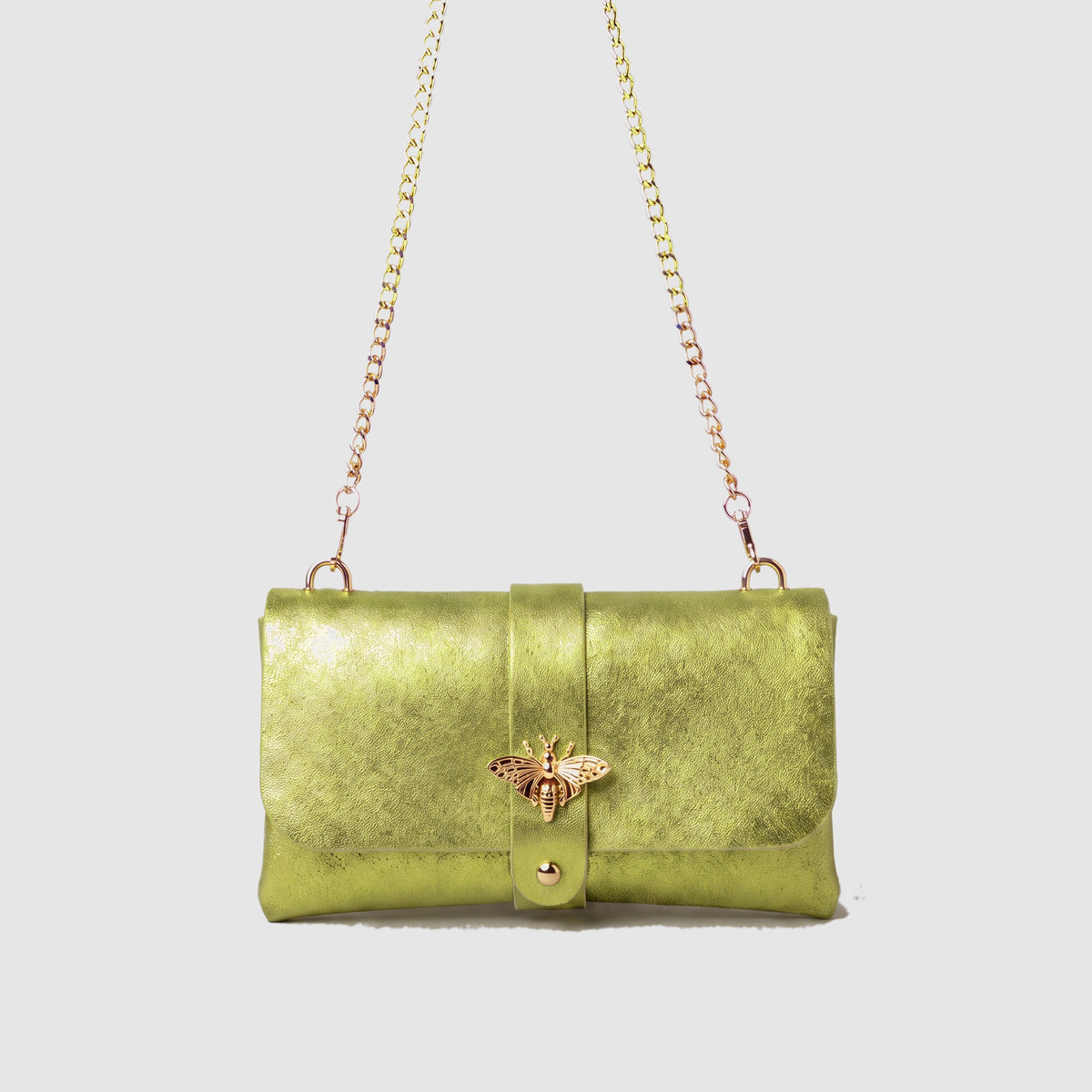 Anima Suede Leather Metallic Clutch Shoulder Bag by Clemés in Apple Green, studio shot on grey background