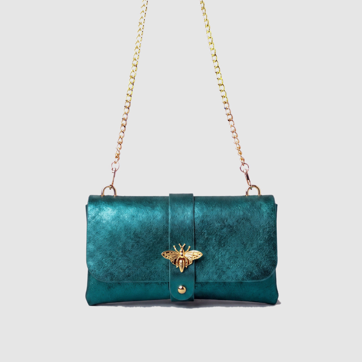 Anima Suede Leather Metallic Clutch Shoulder Bag by Clemés in Teal, studio shot on grey background