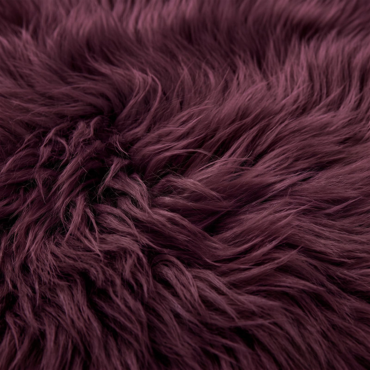 Close-up of Aubergine sheepskin wool showing the rich dark plum fibres