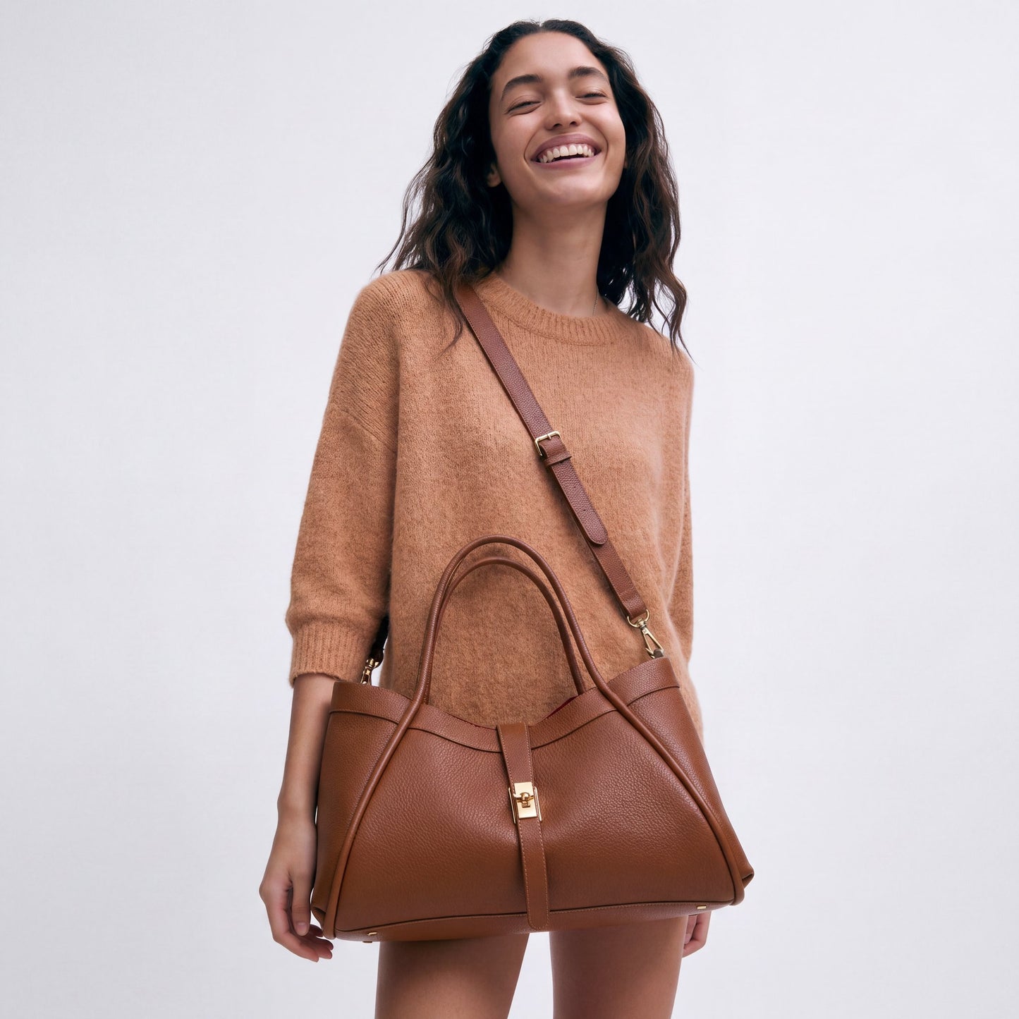 Model wearing the Dark Tan Bianca Large Leather Handbag by Clemés crossbody, studio shot