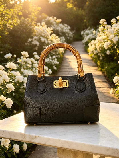 Medium Ginevra bamboo-handle leather bag in Black styled on a marble ledge
