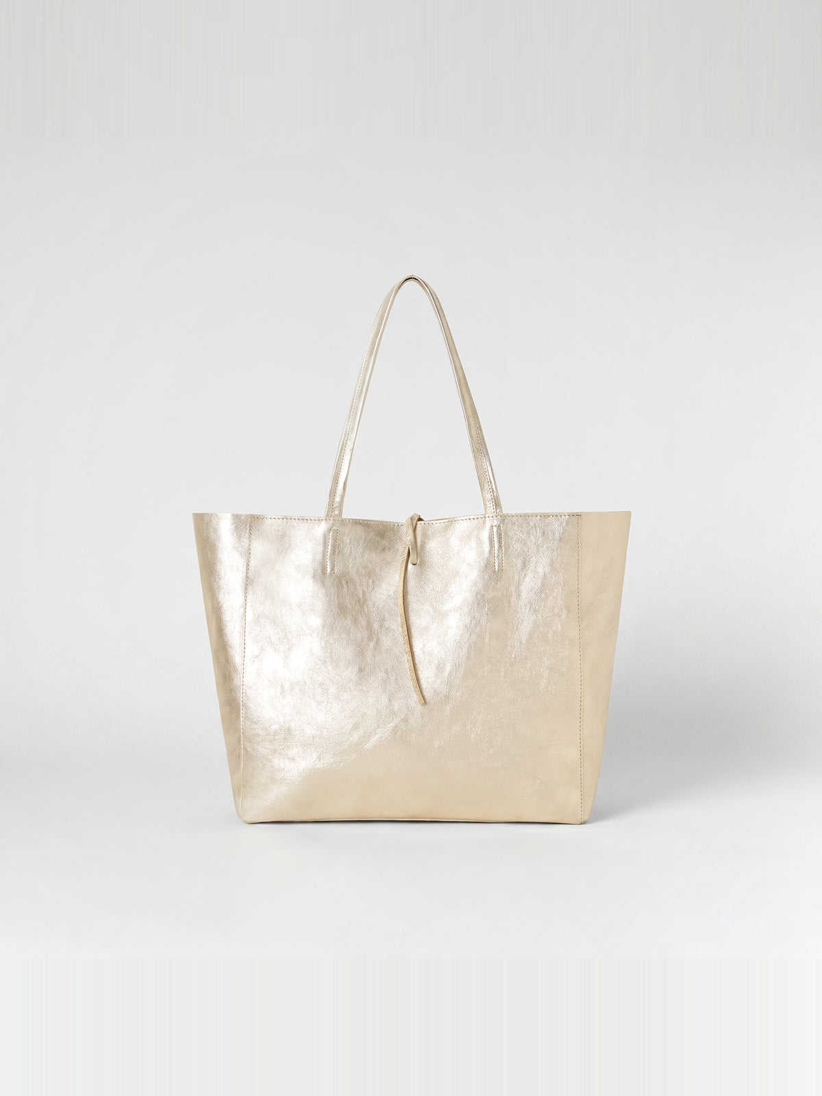 Carlotta oversized leather tote by Clemés in Champagne Gold metallic leather, straight front studio view