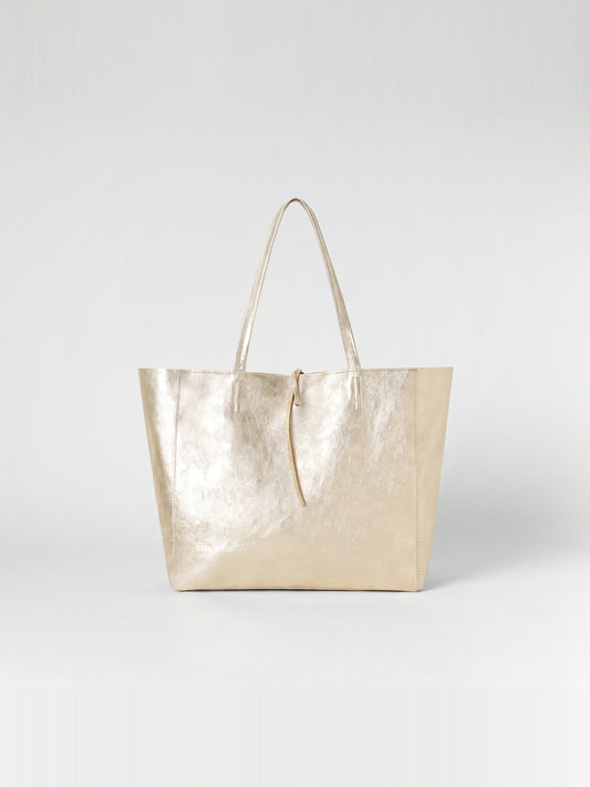 Carlotta oversized leather tote by Clemés in Champagne Gold metallic leather, straight front studio view