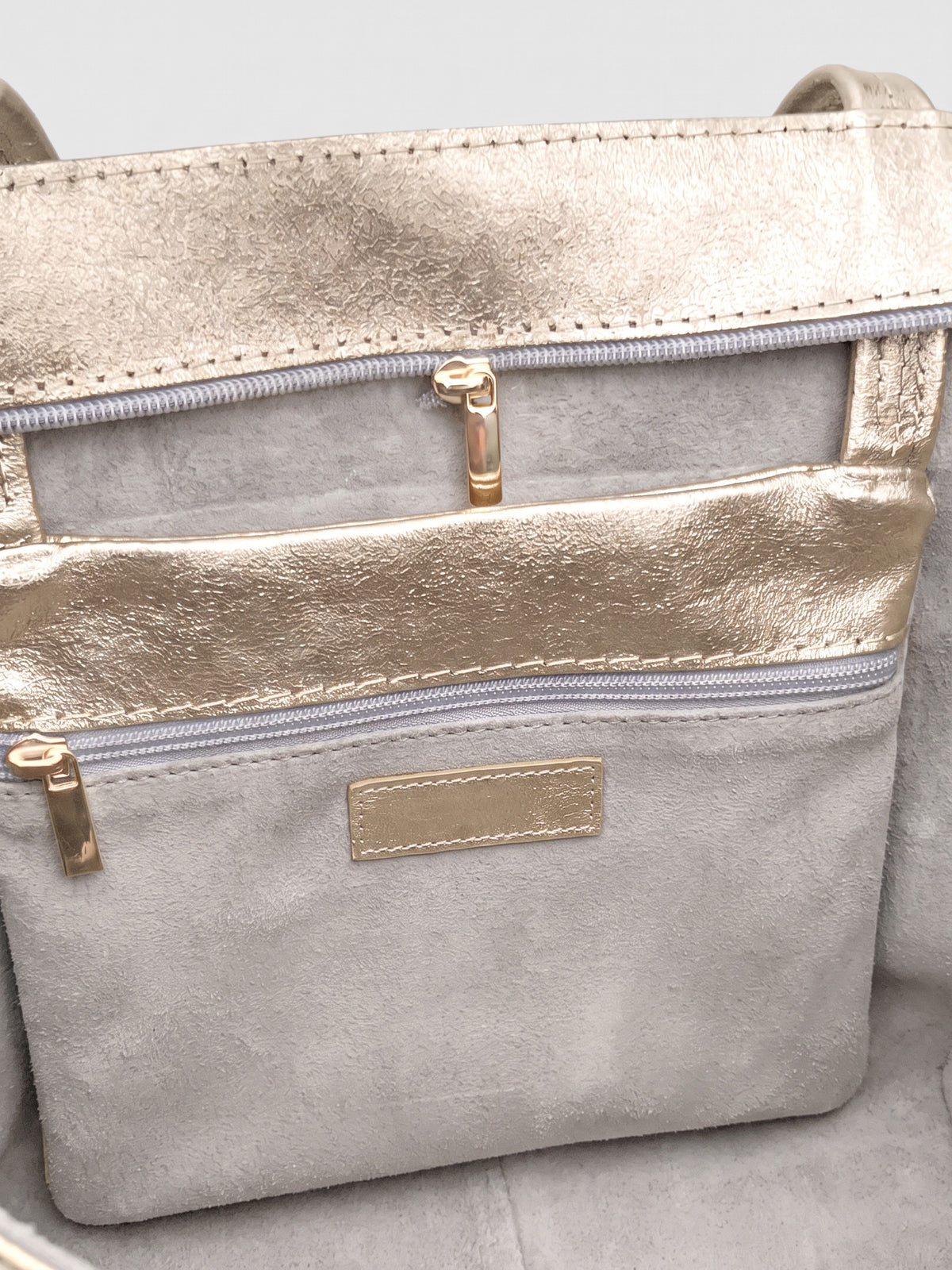 Carlotta oversized leather tote by Clemés in Champagne Gold metallic leather, inside zip pocket and top zip detail