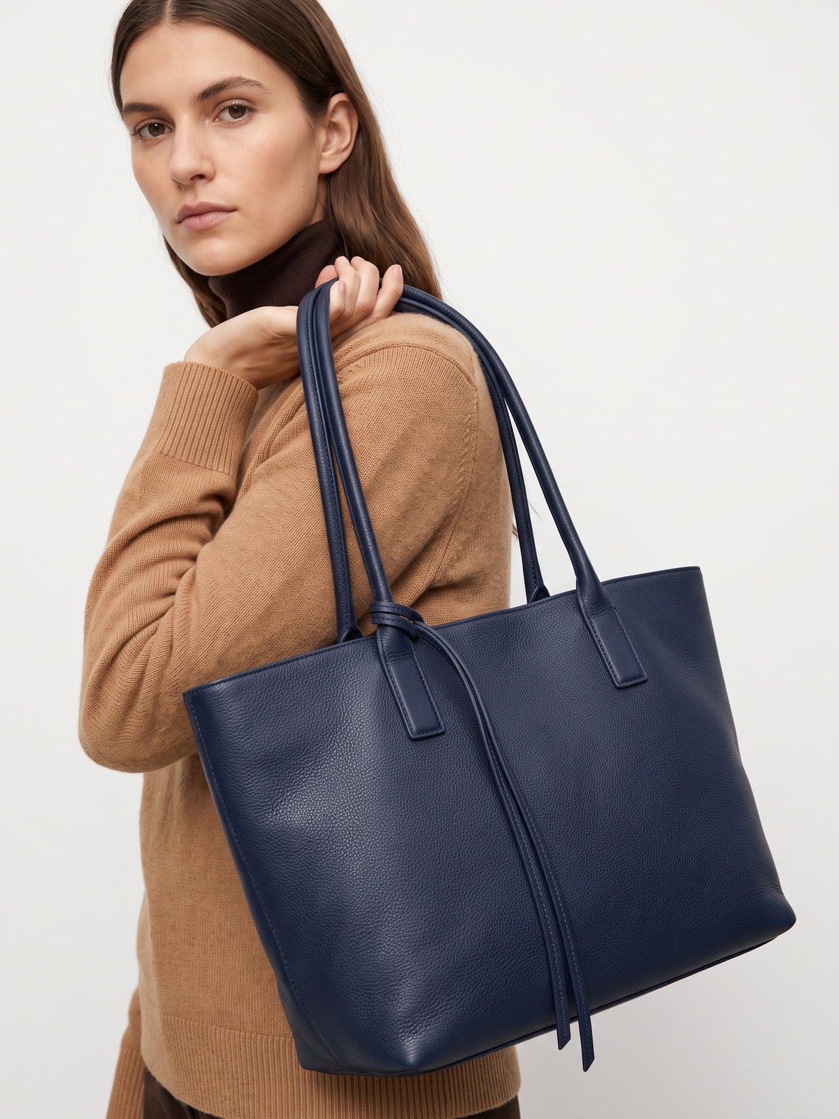 Carlotta oversized leather tote by Clemés in Navy leather, lifestyle shot carried by a model