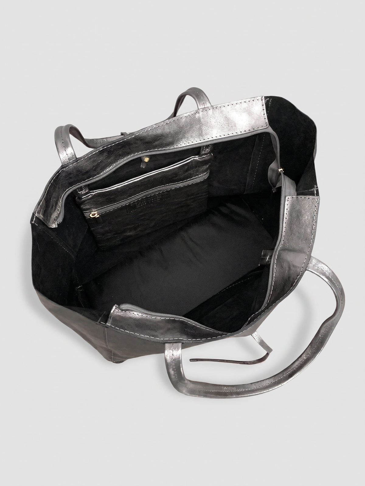 Carlotta oversized leather tote by Clemés in Titanium metallic leather, interior view showing the black suede lining and zip pocket