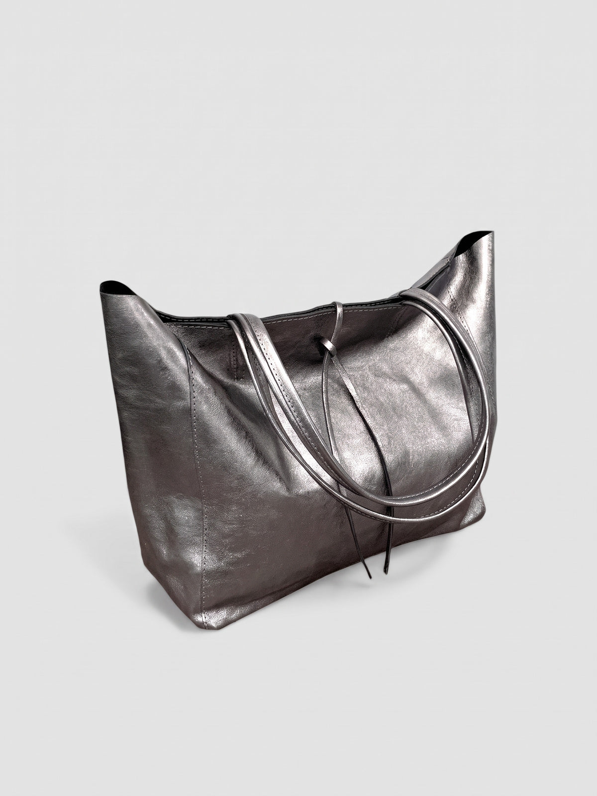 Carlotta oversized leather tote by Clemés in Titanium metallic leather, three-quarter studio view