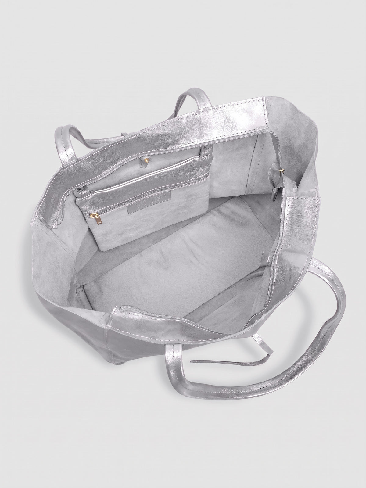 Carlotta oversized leather tote by Clemés in Silver metallic leather, interior view showing the light grey suede lining and zip pocket