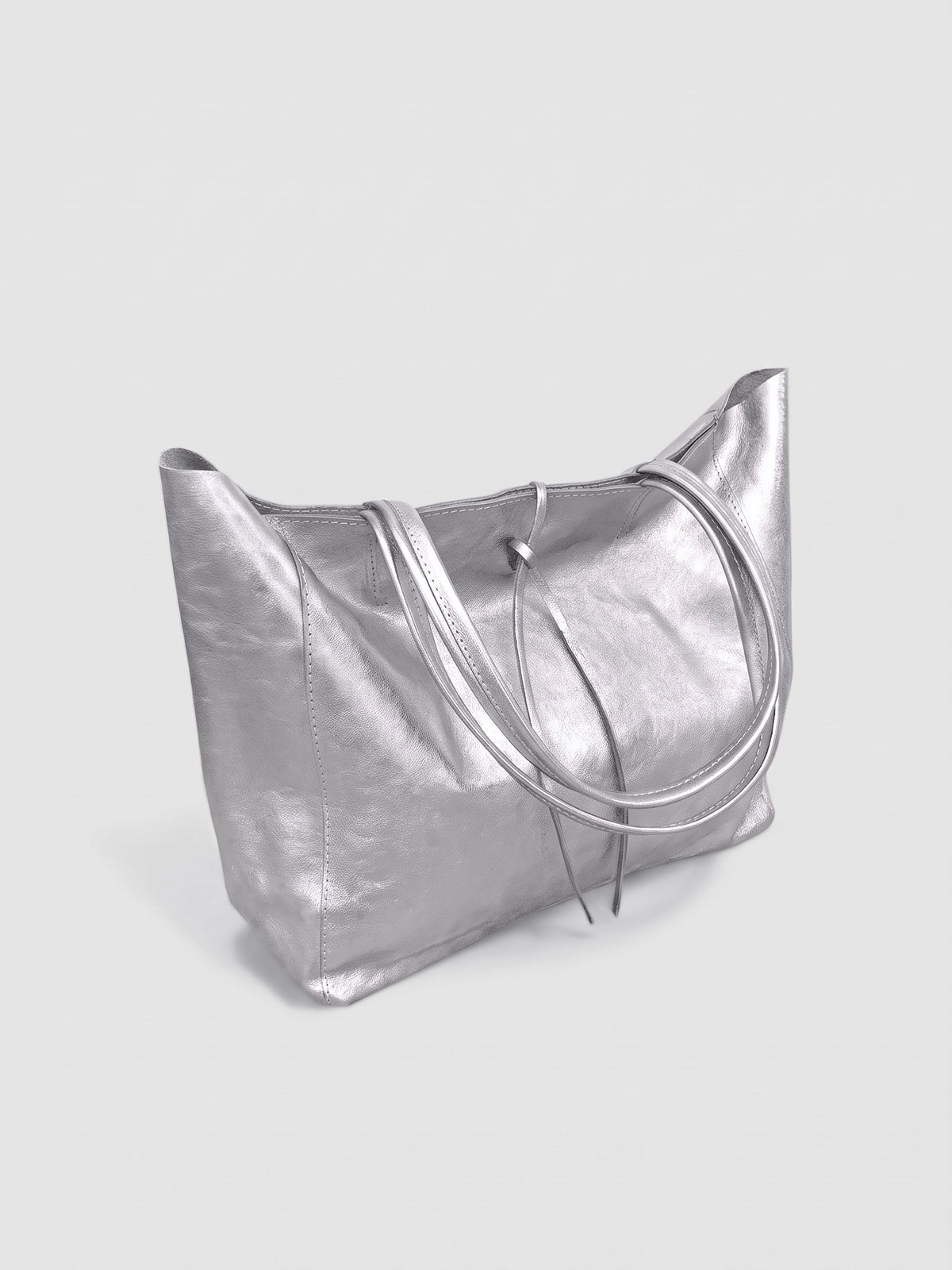 Carlotta oversized leather tote by Clemés in Silver metallic leather, three-quarter studio view