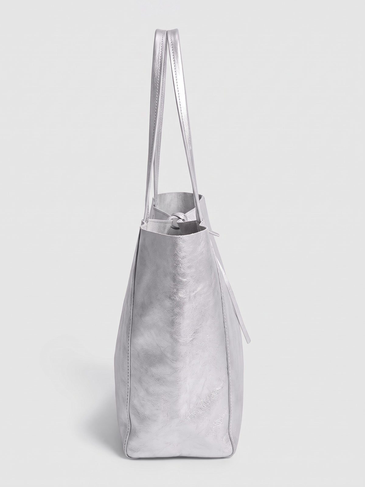Carlotta oversized leather tote by Clemés in Silver metallic leather, side profile view