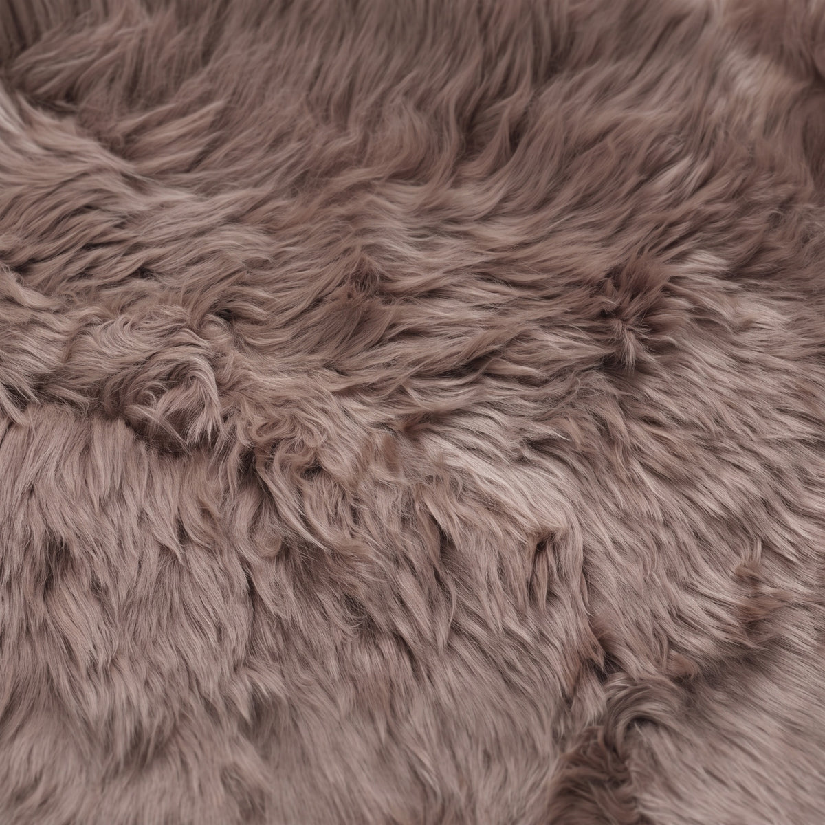 Close-up of the long, dense taupe New Zealand sheepskin wool