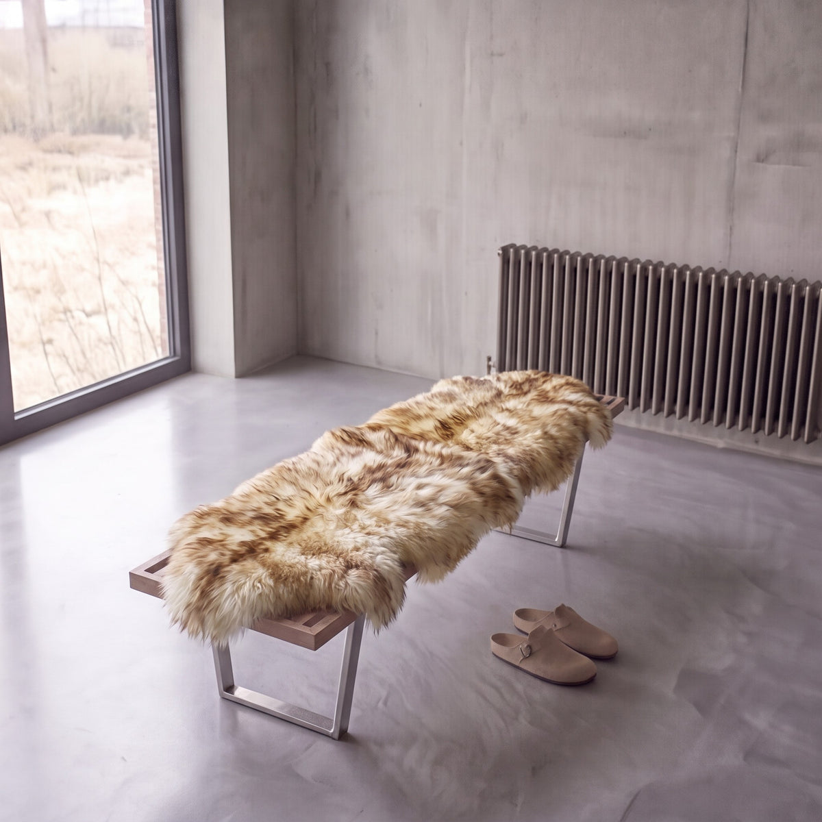 Eclipse double New Zealand sheepskin rug and throw laid on a bench in a minimalist room