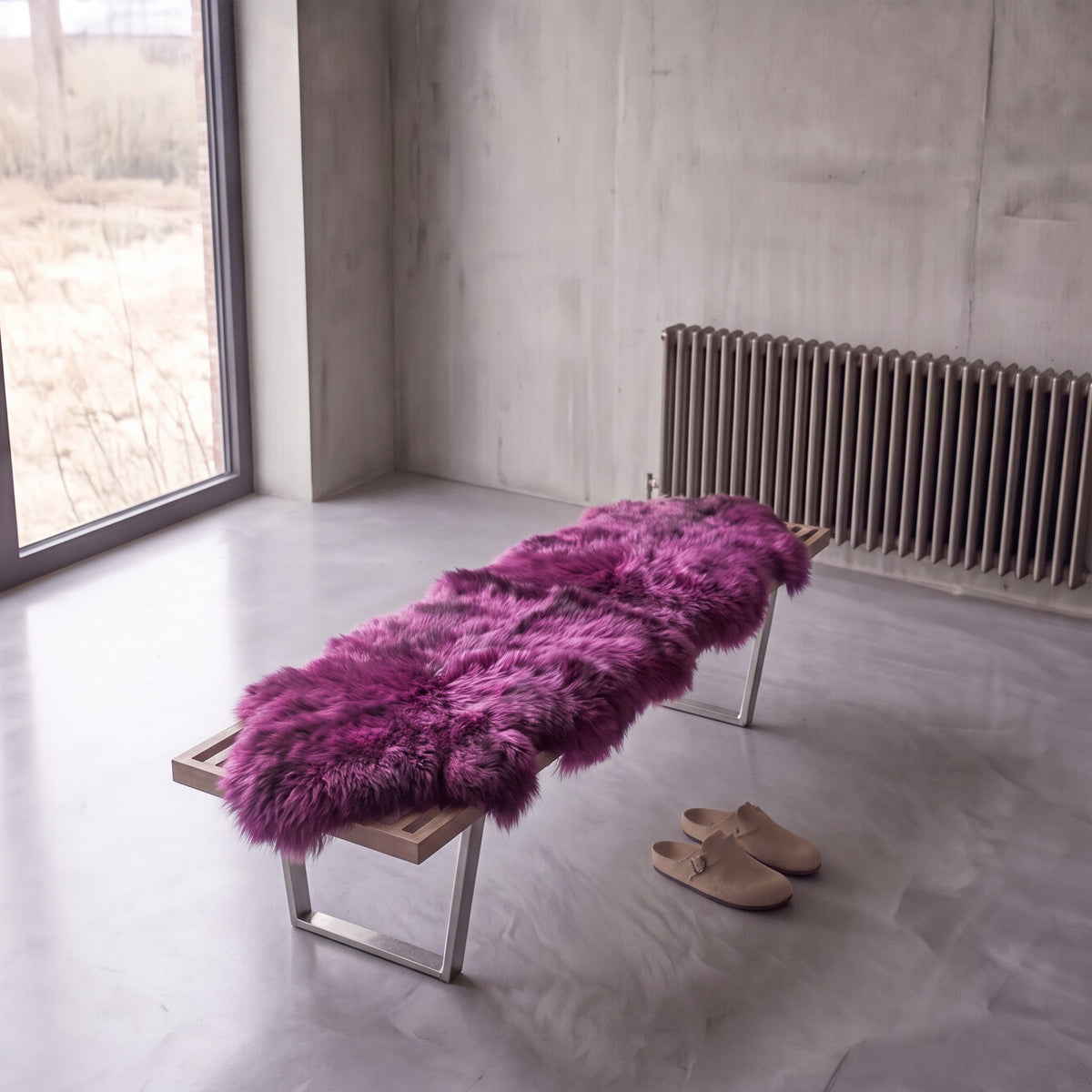 Medici double New Zealand sheepskin rug and throw laid on a bench in a minimalist room