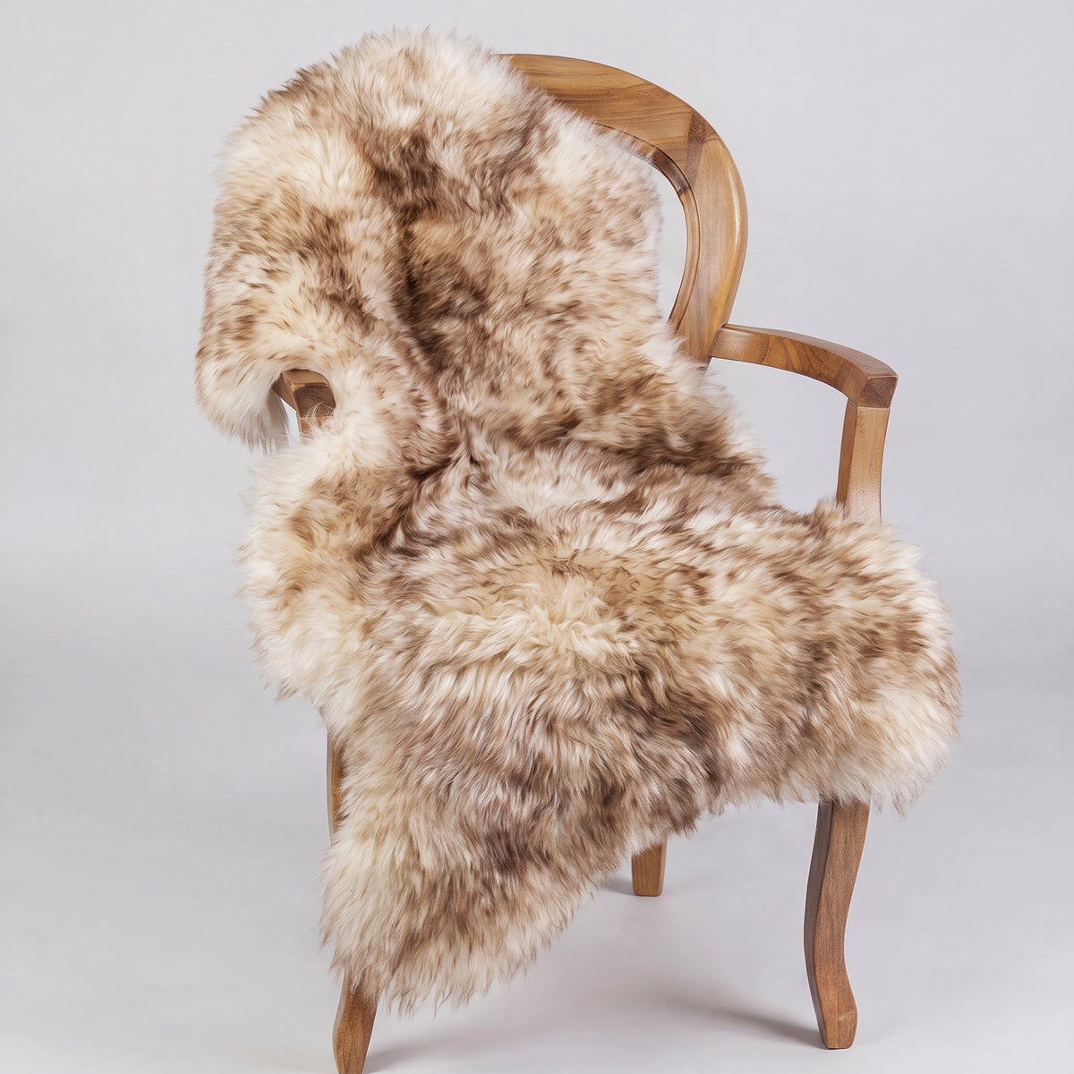 Eclipse single long wool sheepskin rug draped over a wooden armchair
