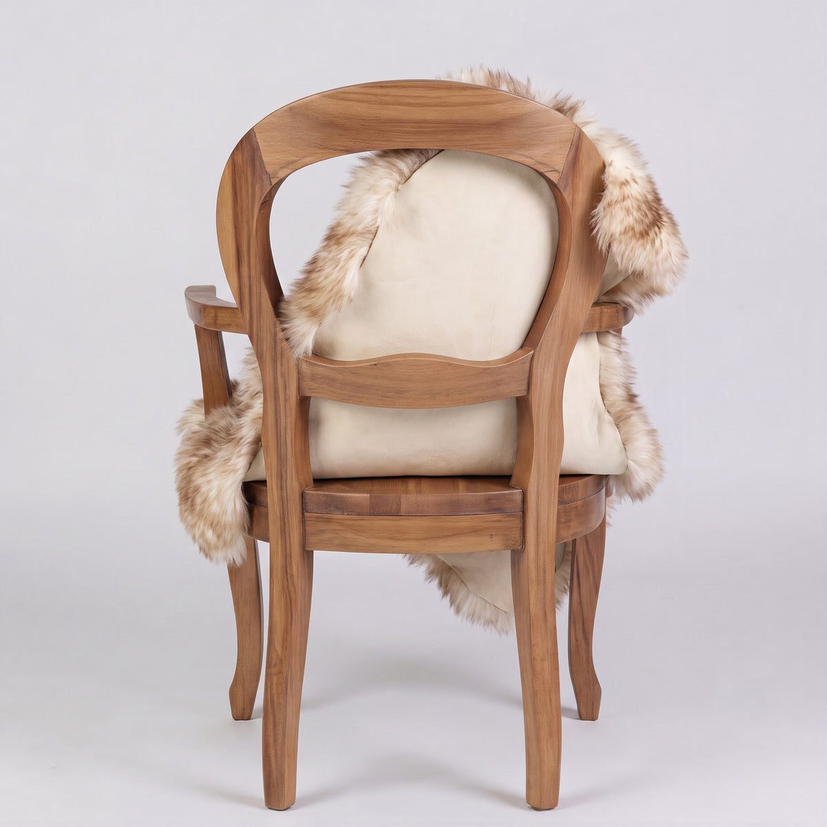 Eclipse sheepskin rug over the back of a chair showing the cream suede underside