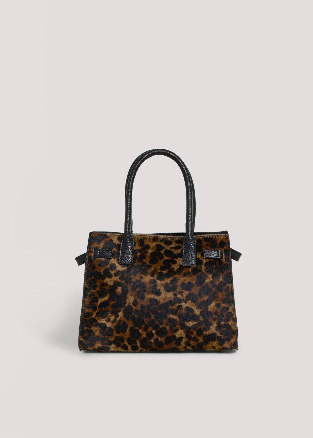 Leonora leopard calf hair top-handle bag, straight-on front view with twin rolled black leather handles