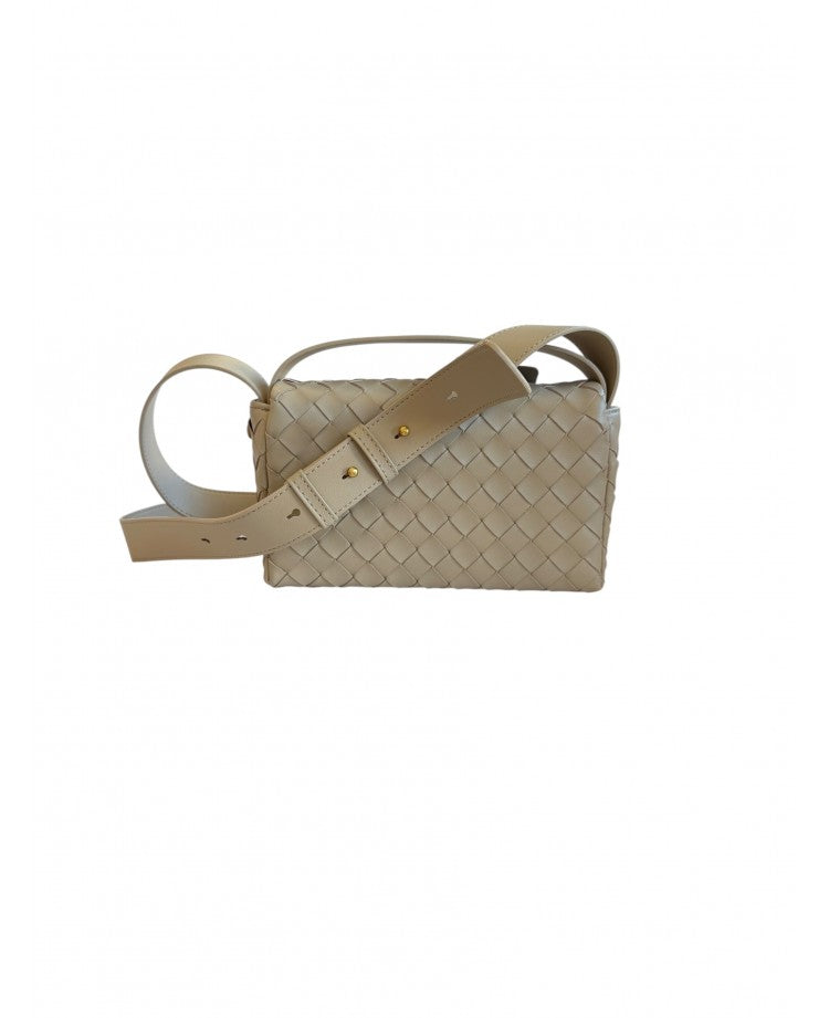 Elettra woven leather crossbody bag in Beige with the adjustable leather strap laid across the front