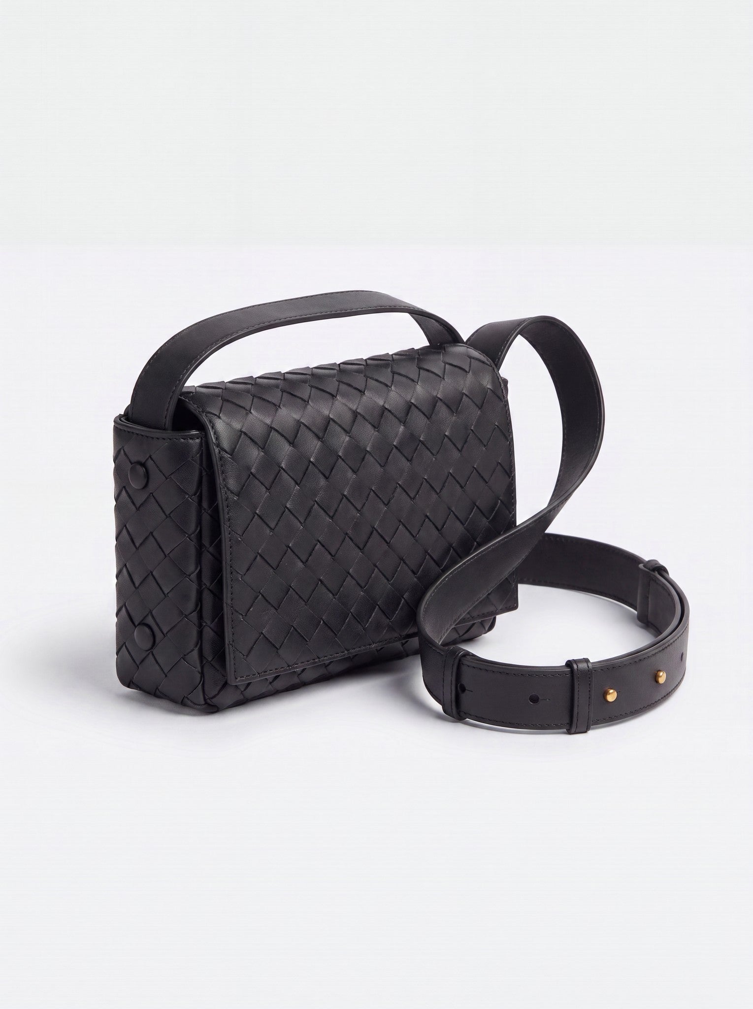Elettra woven leather crossbody bag by Clemés in Black, studio three-quarter view