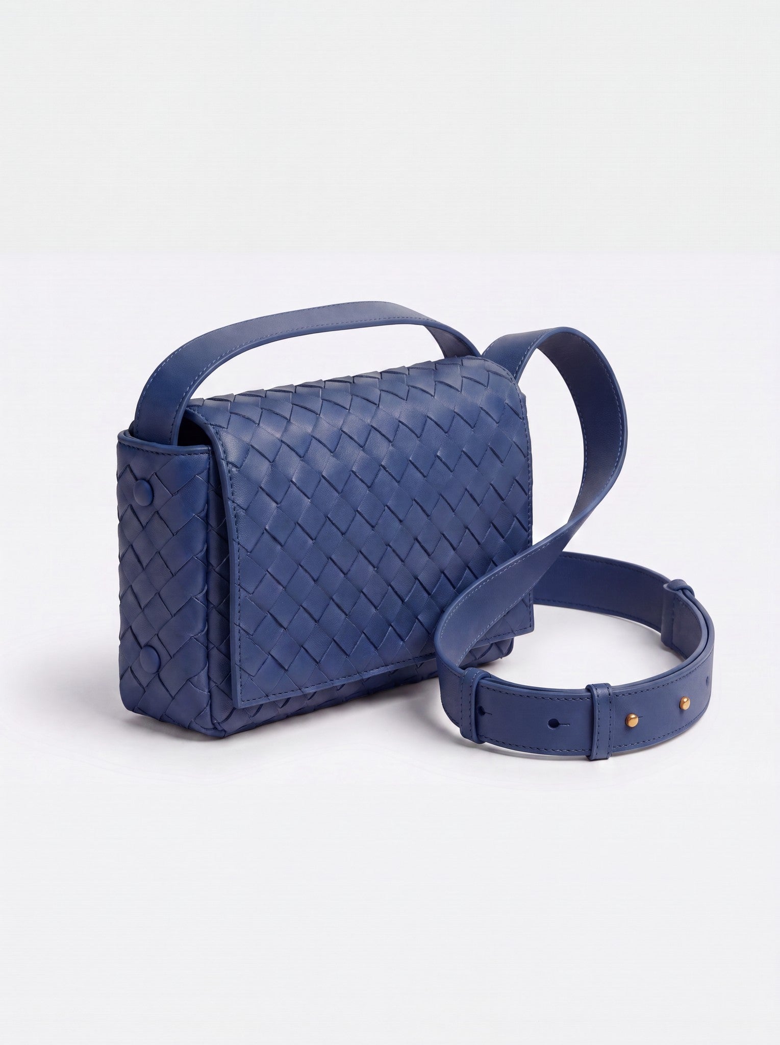 Elettra woven leather crossbody bag by Clemés in Blue, studio three-quarter view