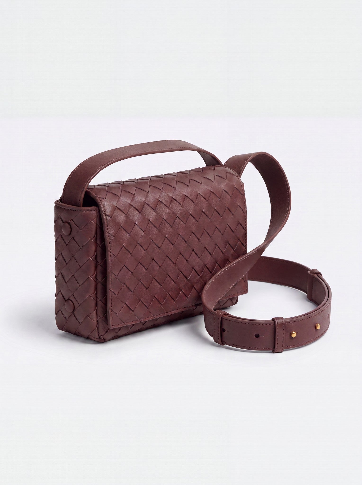 Elettra woven leather crossbody bag by Clemés in Burgundy, studio three-quarter view