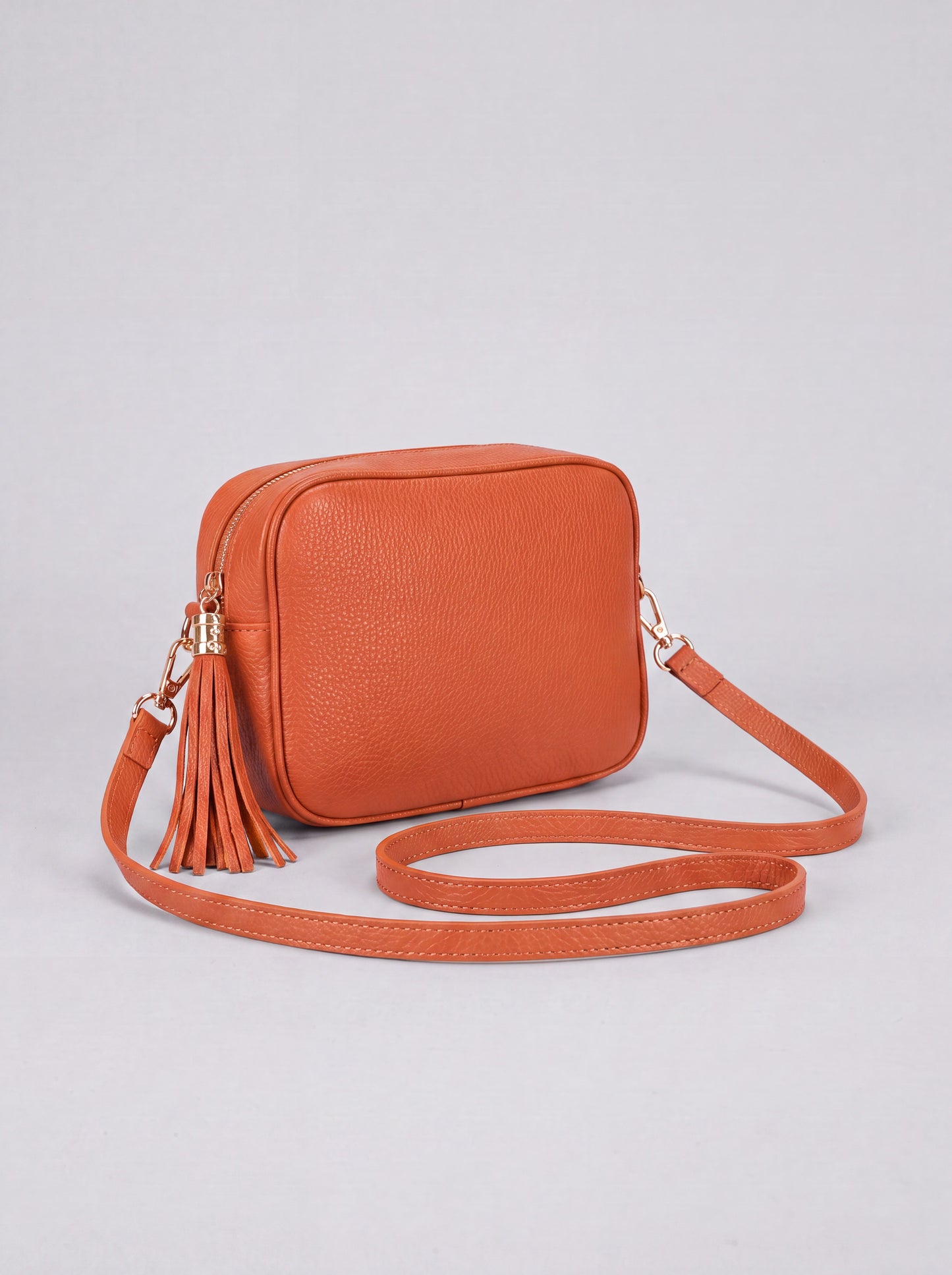 Éloise Leather Tassel Camera Bag by Clemés in Tangerine — studio product photo