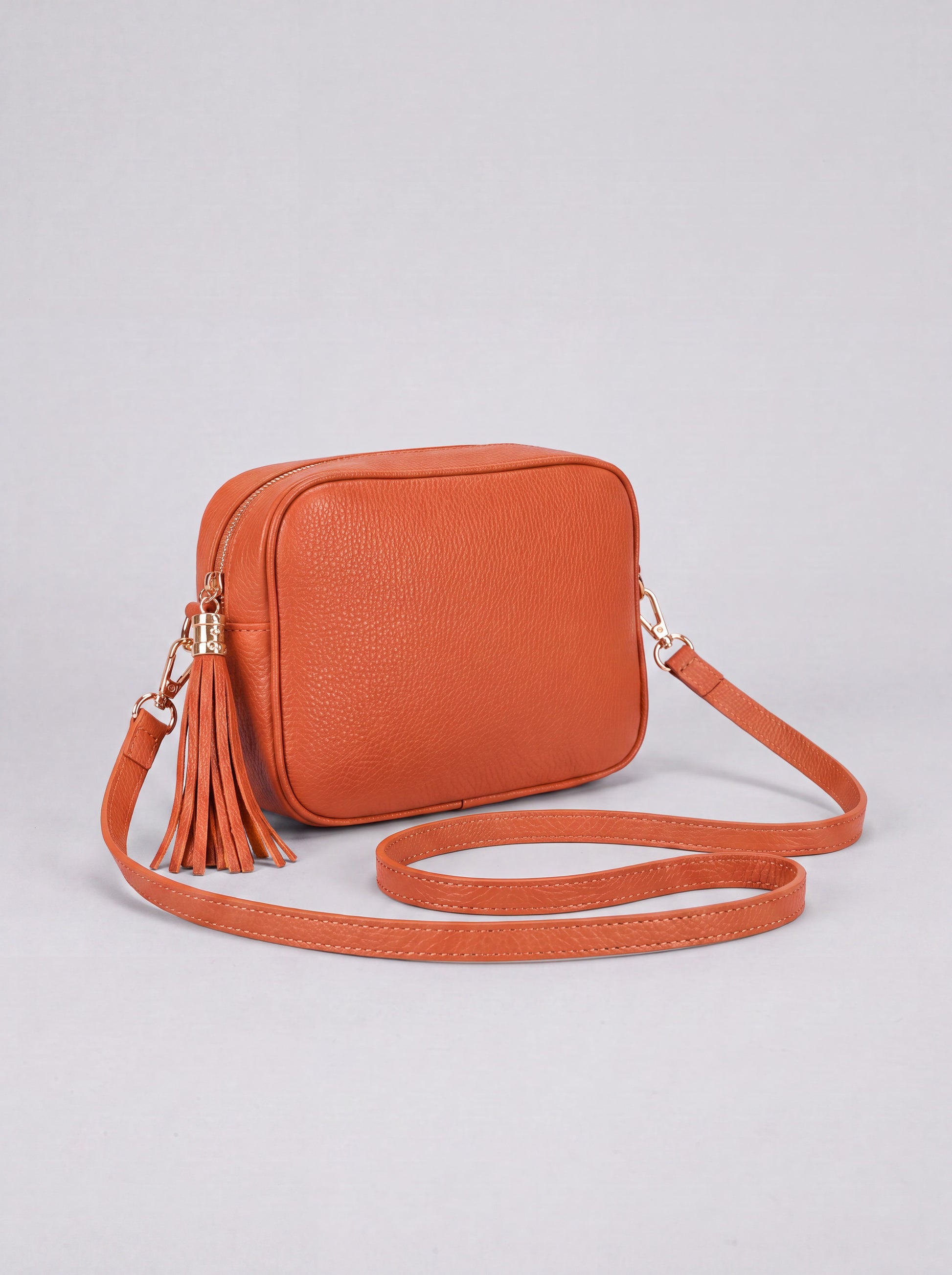 Éloise Leather Tassel Camera Bag by Clemés in Tangerine — studio product photo