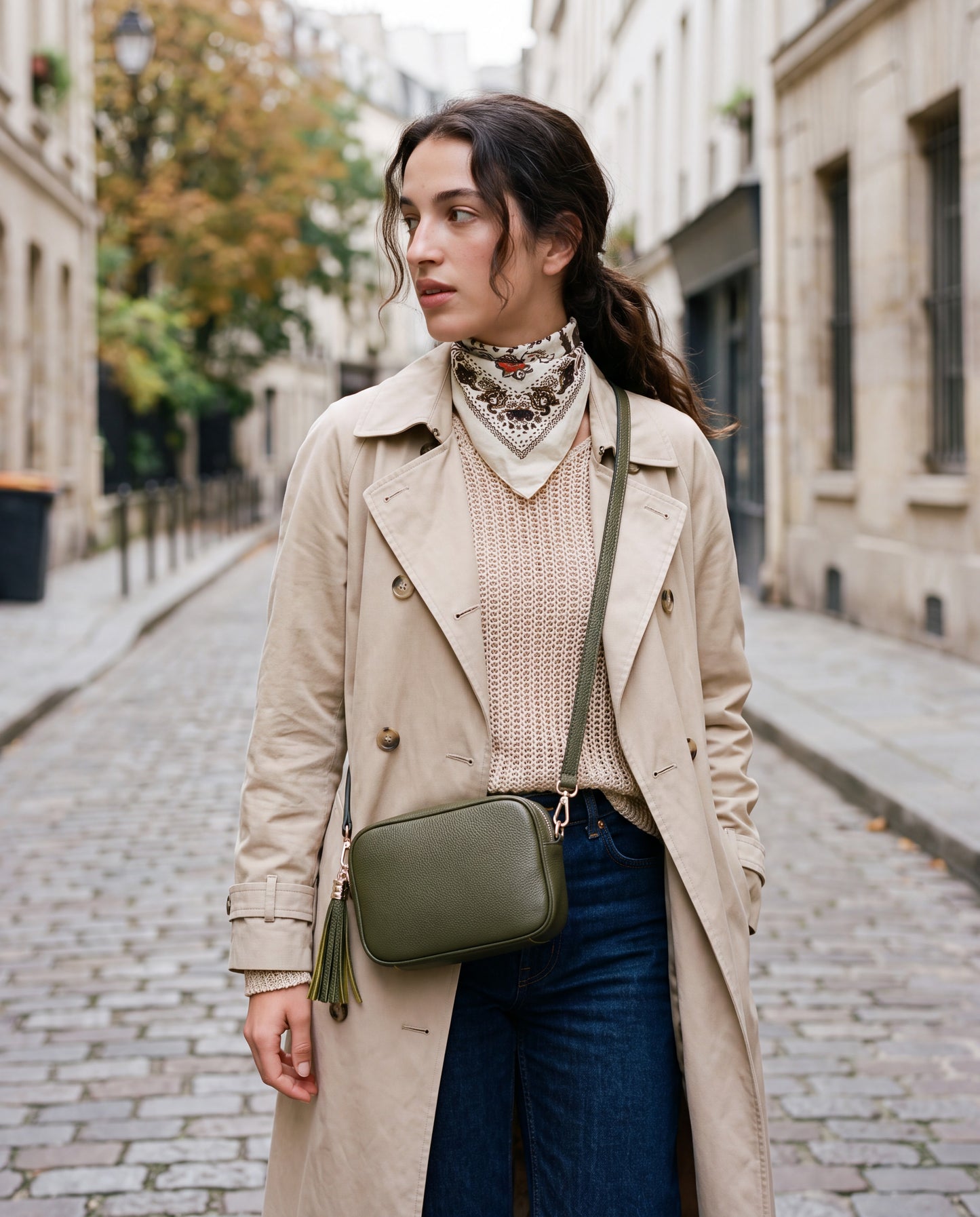 Model with the Olive Éloise Leather Tassel Camera Bag by Clemés on a Parisian street in a trench coat