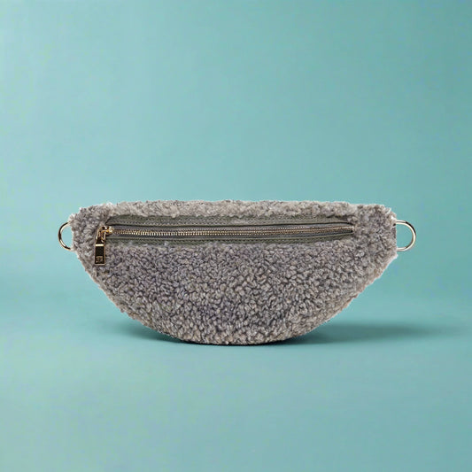 Nevina shearling and leather bum bag in Dover grey on a teal studio background