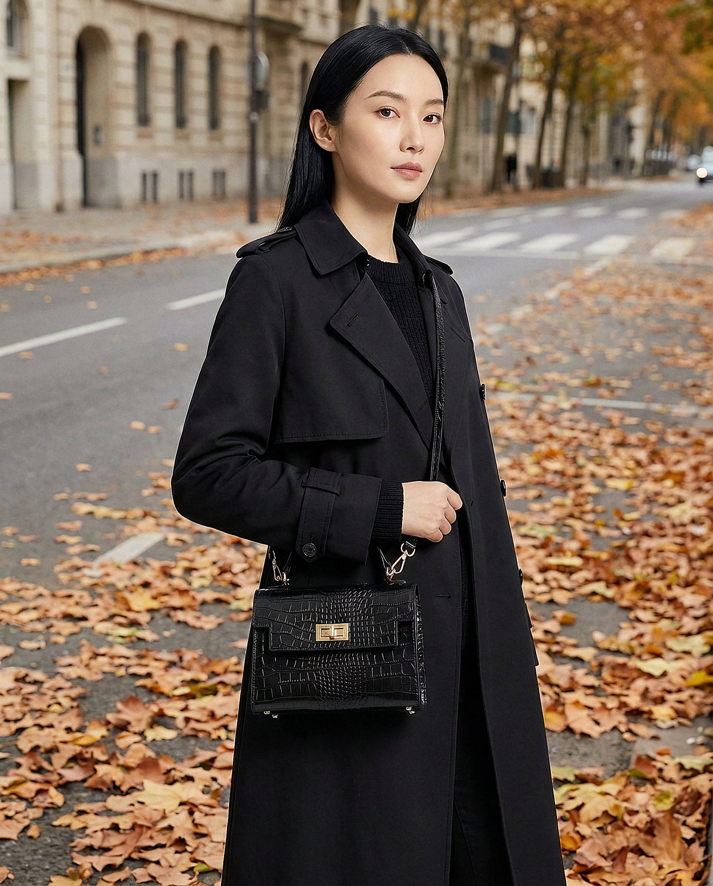 Woman with the Black Margot Croc crossbody bag on an autumn city street
