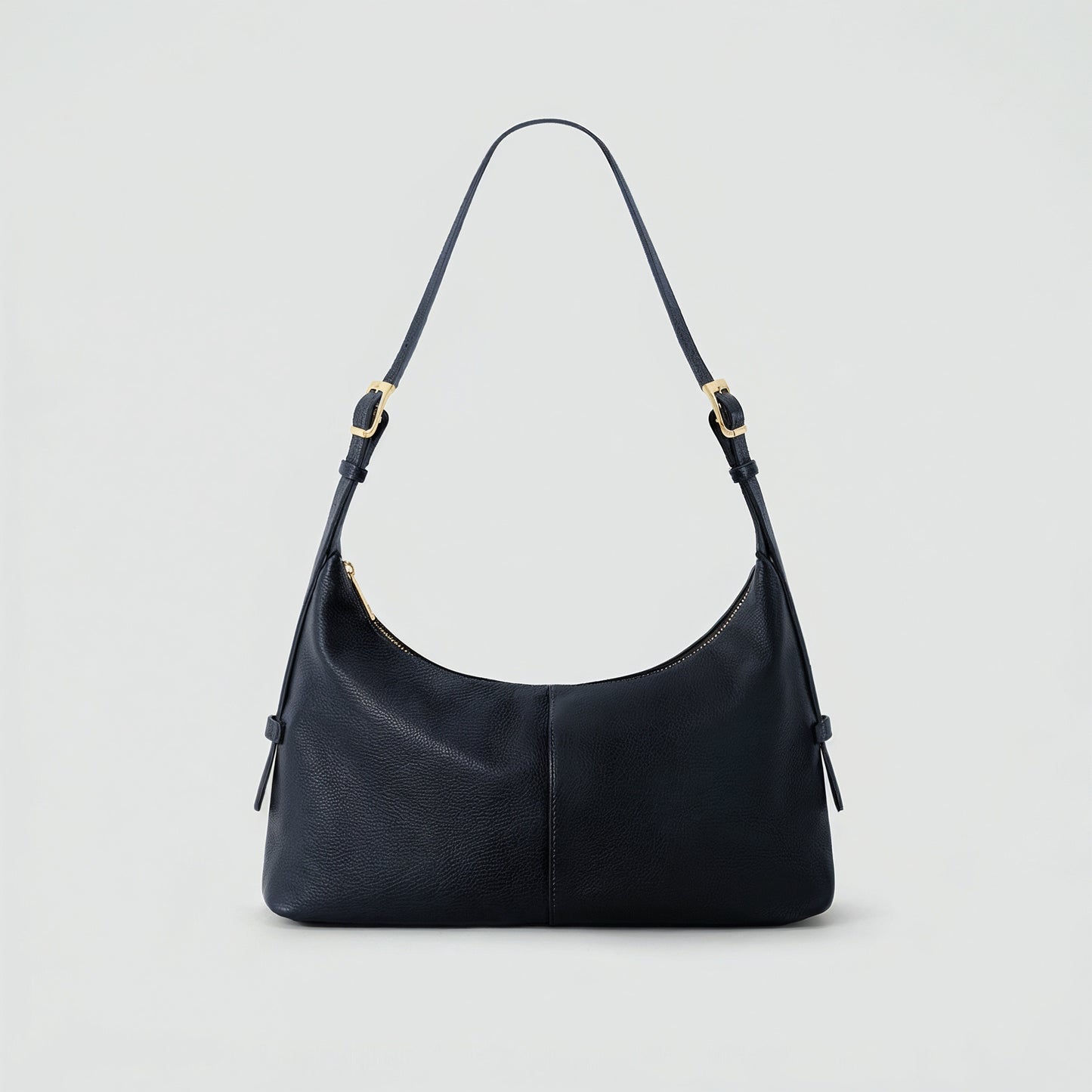 Elettra leather shoulder bag in navy on a light grey studio background